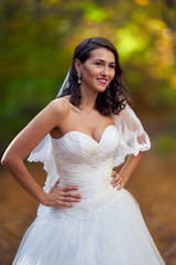 Fototapeta na wymiar Bride in white dress in the forest