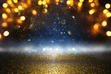abstract glitter black, blue and gold lights background. de-focused
