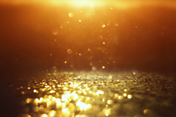 background of abstract glitter lights. gold and black. de focused
