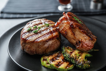 Closeup view of delicious grilled beef medallions served on table