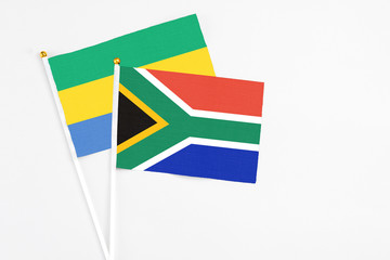 South Africa and Gabon stick flags on white background. High quality fabric, miniature national...