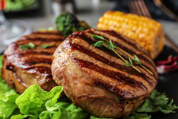 Closeup view of delicious grilled beef medallions on table