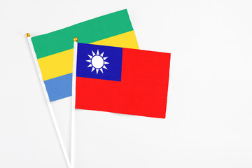 Taiwan and Gabon stick flags on white background. High quality fabric, miniature national flag....