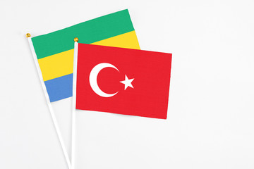 Turkey and Gabon stick flags on white background. High quality fabric, miniature national flag....