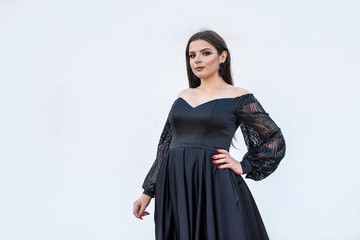 Portrait of beautiful woman. Gorgeous woman in black dress posing isolated on white