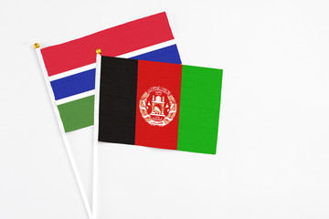 Afghanistan and Georgia stick flags on white background. High quality fabric, miniature national flag. Peaceful global concept.White floor for copy space.
