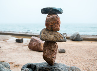 Fototapeta na wymiar rocks balance on the seaside promenade, gravity balance of stones