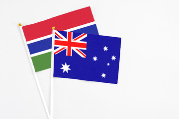 Fototapeta premium Australia and Georgia stick flags on white background. High quality fabric, miniature national flag. Peaceful global concept.White floor for copy space.