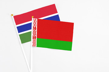 Belarus and Georgia stick flags on white background. High quality fabric, miniature national flag. Peaceful global concept.White floor for copy space.