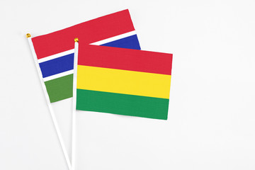 Bolivia and Georgia stick flags on white background. High quality fabric, miniature national flag. Peaceful global concept.White floor for copy space.