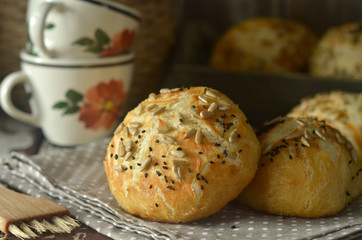 Freshly baked pretzel rolls sprinkled with poppy seeds