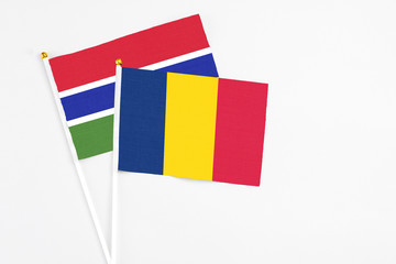 Chad and Georgia stick flags on white background. High quality fabric, miniature national flag. Peaceful global concept.White floor for copy space.