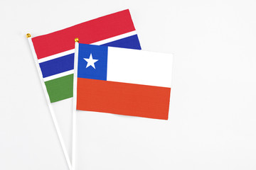 Chile and Georgia stick flags on white background. High quality fabric, miniature national flag. Peaceful global concept.White floor for copy space.