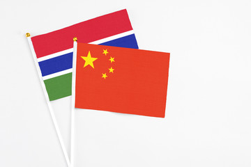 China and Georgia stick flags on white background. High quality fabric, miniature national flag. Peaceful global concept.White floor for copy space.
