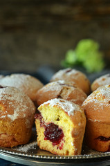 Muffins with jam on a rustic round tray