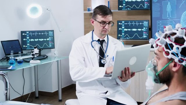 Doctor in brain research using his laptop in a modern centre of neuroscience