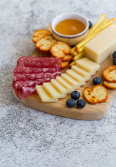 Delicious cheese served with berries, crackers and salami