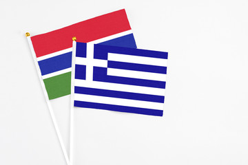 Greece and Georgia stick flags on white background. High quality fabric, miniature national flag. Peaceful global concept.White floor for copy space.