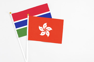 Hong Kong and Georgia stick flags on white background. High quality fabric, miniature national flag. Peaceful global concept.White floor for copy space.