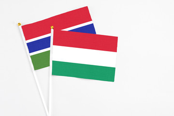 Hungary and Georgia stick flags on white background. High quality fabric, miniature national flag. Peaceful global concept.White floor for copy space.