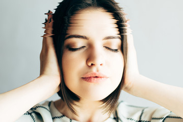 Fototapeta premium Young woman is having headache and stress, closeup portrait with special effect