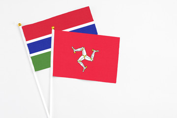 Isle Of Man and Georgia stick flags on white background. High quality fabric, miniature national flag. Peaceful global concept.White floor for copy space.