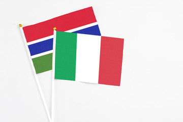Fototapeta premium Italy and Georgia stick flags on white background. High quality fabric, miniature national flag. Peaceful global concept.White floor for copy space.
