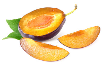 plum slices with green leaves isolated on a white background