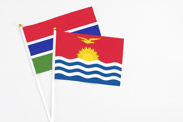 Kiribati and Georgia stick flags on white background. High quality fabric, miniature national flag. Peaceful global concept.White floor for copy space.