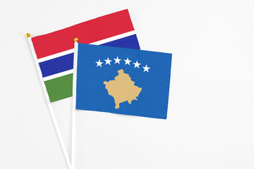 Kosovo and Georgia stick flags on white background. High quality fabric, miniature national flag. Peaceful global concept.White floor for copy space.