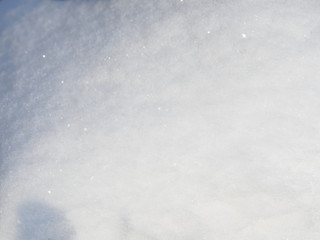 Abstract background, pure snow closeup, in the light of the morning sun