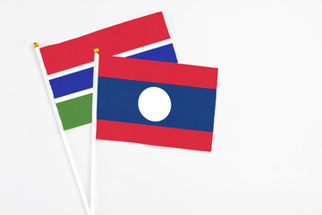Laos and Georgia stick flags on white background. High quality fabric, miniature national flag. Peaceful global concept.White floor for copy space.