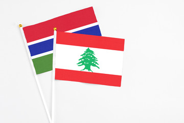 Lebanon and Georgia stick flags on white background. High quality fabric, miniature national flag. Peaceful global concept.White floor for copy space.