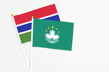 Macao and Georgia stick flags on white background. High quality fabric, miniature national flag. Peaceful global concept.White floor for copy space.