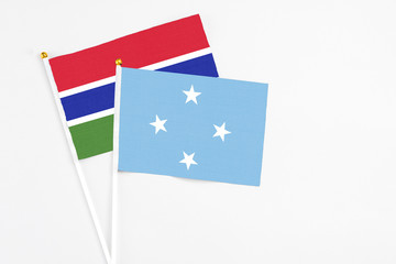 Micronesia and Georgia stick flags on white background. High quality fabric, miniature national flag. Peaceful global concept.White floor for copy space.