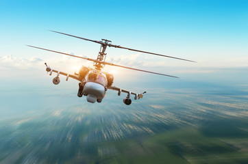 Combat military helicopter with weapons flies over the city.