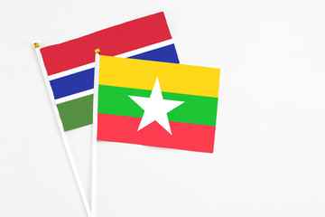 Myanmar and Georgia stick flags on white background. High quality fabric, miniature national flag. Peaceful global concept.White floor for copy space.
