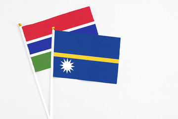 Nauru and Georgia stick flags on white background. High quality fabric, miniature national flag. Peaceful global concept.White floor for copy space.
