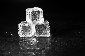 ice cubes on black table background.