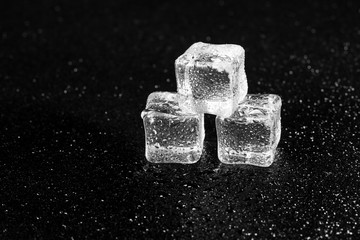ice cubes on black table background.