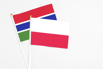 Poland and Georgia stick flags on white background. High quality fabric, miniature national flag. Peaceful global concept.White floor for copy space.