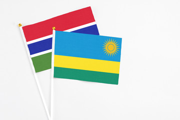 Rwanda and Georgia stick flags on white background. High quality fabric, miniature national flag. Peaceful global concept.White floor for copy space.