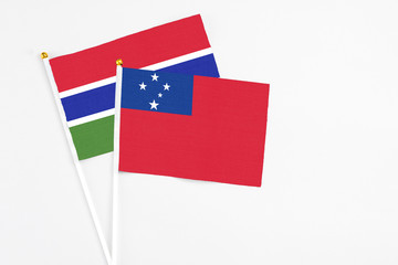 Samoa and Georgia stick flags on white background. High quality fabric, miniature national flag. Peaceful global concept.White floor for copy space.