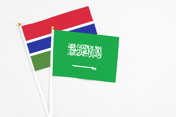 Saudi Arabia and Georgia stick flags on white background. High quality fabric, miniature national flag. Peaceful global concept.White floor for copy space.