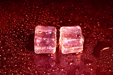 ice cubes on a reflections red light.