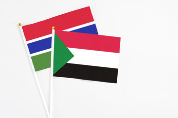Sudan and Georgia stick flags on white background. High quality fabric, miniature national flag. Peaceful global concept.White floor for copy space.