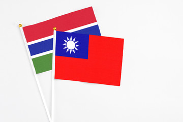 Taiwan and Georgia stick flags on white background. High quality fabric, miniature national flag. Peaceful global concept.White floor for copy space.