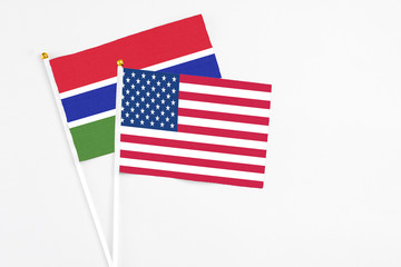 United States and Georgia stick flags on white background. High quality fabric, miniature national flag. Peaceful global concept.White floor for copy space.