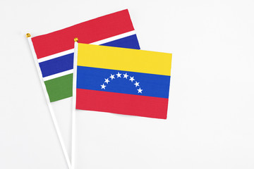 Venezuela and Georgia stick flags on white background. High quality fabric, miniature national flag. Peaceful global concept.White floor for copy space.