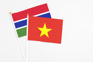 Vietnam and Georgia stick flags on white background. High quality fabric, miniature national flag. Peaceful global concept.White floor for copy space.